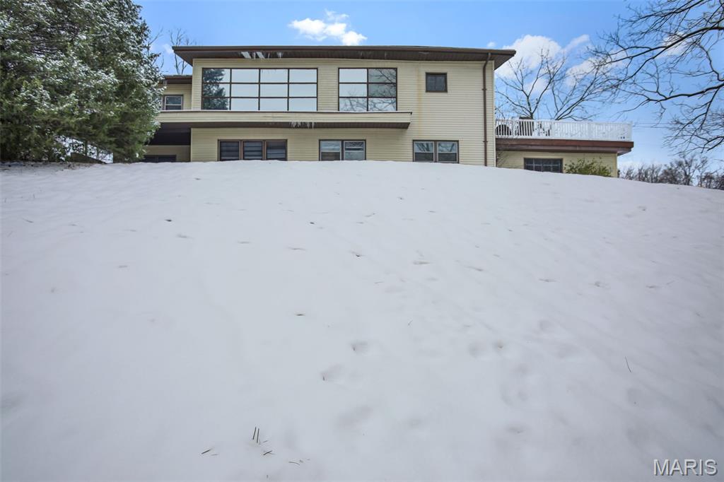 Enjoy privacy and space in this 4BD/2BTH updated home in Knollwood Subdivision.  Covered patio entry welcomes you into the family room with fireplace, three bedrooms, full bath, laundry and entry to one garage garage.  Second level entry off composite deck welcomes you into updated family room with fireplace and luxury vinyl plank flooring.  Kitchen remodel with SS appliances, laminate counters and island.  Primary bedroom with lots of closet space, and adjacent suite.  Primary bath includes ceramic tile, dual vanity, separate tub/shower.