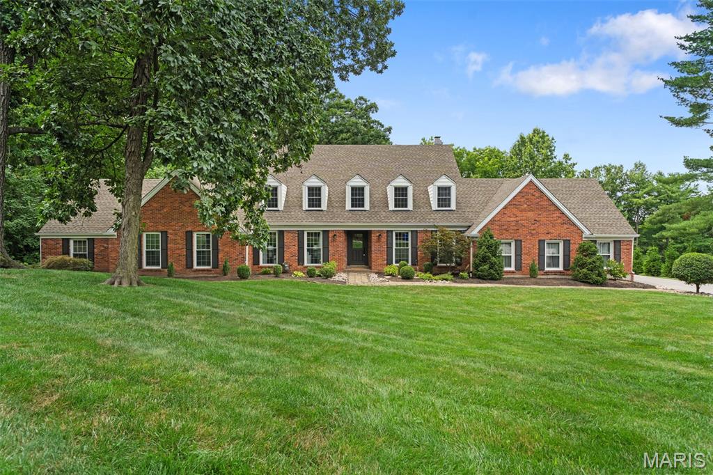 Nestled on a private, wooded 1-acre lot yet just moments from the charm of Longview Farm Park and the boutique shops and restaurants of Mason Village, this custom-built 1.5-story residence offers the rare combination of tranquil seclusion and coveted walkability. With 4 bedrooms and 3.5 baths, the home offers space and flexibility for everyday living as well as effortless entertaining. The open, light-filled floor plan is anchored by an inviting family room, where a cozy wood-burning fireplace serves as the heart of the home, flowing effortlessly into the gourmet kitchen - featuring stainless steel appliances and an expansive island - or out to a sun-drenched sunroom offering a serene escape overlooking the private, tree-lined backdrop. The main-level primary suite serves as a true sanctuary, complete with a luxurious soaking tub for quiet, spa-like moments at home. Upstairs, a second primary or guest suite offers exceptional flexibility, featuring its own en suite bath and private sitting room, perfect for visiting guests. A laundry room is also conveniently located upstairs, adding effortless ease to daily living. The finished lower level extends the living space further with a spacious recreation room and ample storage, ideal for a home gym, media room, or additional entertaining space. Every bathroom throughout the home has been beautifully updated, and thoughtful details carry through the entire property - offering a rare combination of privacy, luxury, and location all in one exceptional home.