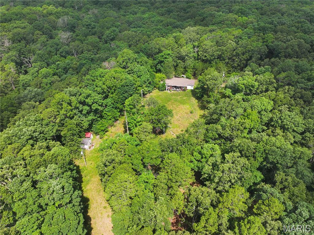 $80,000 - 9.6 ac +/- Off TT Highway, Poplar Bluff, Mo 63901. Wooded acreage joins Foxwood Pointe Subdivision at the entrance. No restrictions with older uninhabitable dwelling.