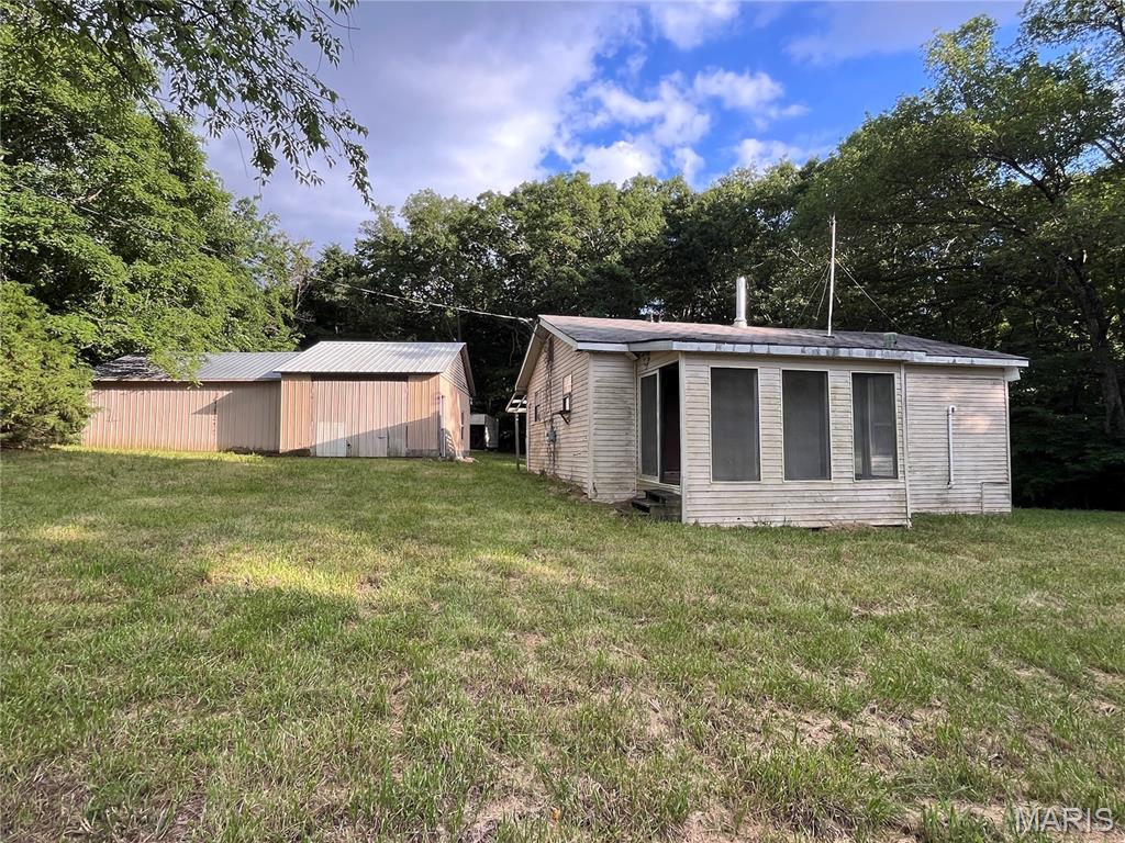 4.59 acres rolling hills, cleared pasture with home, powered garage/workshop, shed and outhouse. Peaceful hidden gem to stretch your arms out, weekender project. Home needs remodel including well and septic.  No restrictions- just your imagination.  Private 2 bed, 1 bath cottage /bungalow, 20x24 powered outbuilding garage.