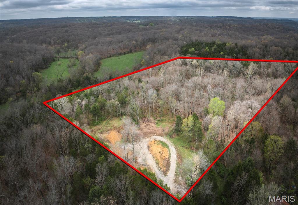 A rare opportunity to own 5.22 private, non-restricted acres in Marthasville. Tucked away at the end of a private road, this property offers a perfect mix of open ground and woods, ideal for your future home or getaway. A peaceful seasonal creek runs through the land, and utilities are nearby with an electric pole at the corner. There’s also an old shared well that may be restored. Quiet, scenic, and full of potential. Located in a great spot that is a short drive to both Washington and HWY 70. Land like this doesn’t come around often-make it yours!