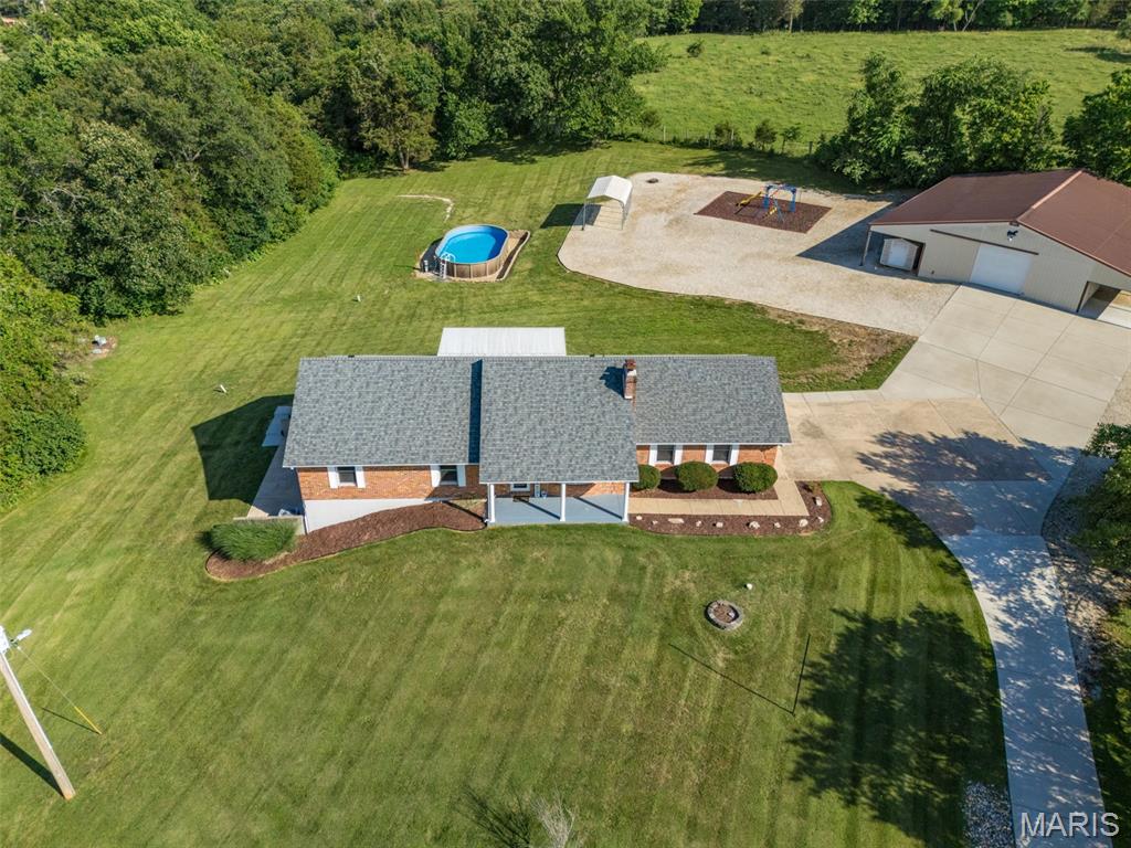A Rare Country Retreat on 6.99 Acres in De Soto!
Looking for privacy, space, and endless possibilities? This incredible full-brick ranch offers the perfect blend of comfortable living and country charm on a breathtaking 6.99-acre setting.
This spacious home features 4 bedrooms, 3 full bathrooms, and an oversized attached 2-car garage. The finished walk-out lower level is ideal for multi-generational living or entertaining, complete with a full second kitchen, expansive family room, abundant storage, and access to a covered patio.
Outside is where this property truly shines! Enjoy summer days by the above-ground pool, a playground area, multiple carport and shed structures for all your equipment and hobbies, and an impressive 36x59 detached building offering endless opportunities for a workshop, business use, vehicles, toys, or storage.
A mostly paved driveway leads you through a gated entrance to your own private, serene retreat surrounded by nature. Properties with this much acreage, versatility, and usable space are hard to find—don't miss your chance to own a one-of-a-kind piece of paradise!