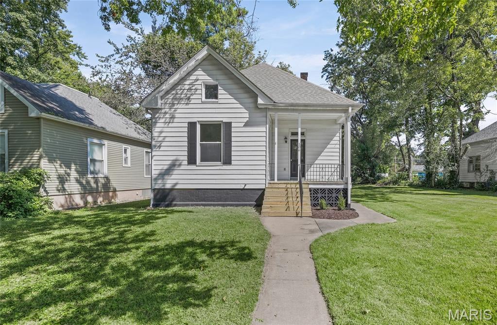 Come see the adorable 2 bedroom/1 bath home newly rehabbed.  From a new covered front porch, walk into a freshly painted new flooring living room with big windows to let the light in!!  One bedroom is in the front of the home with new carpet and also has big windows.   Thru the living room into the kitchen, brand new Quarts counter tops, new appliances and also freshly painted.  In fact the interior home has all  been repainted. The laundry area is in the hall way to the bathroom and the 2nd bedroom that has 2 closets.  If you walk out from the kitchen you will be taken either down to the unfinished basement or to a door out to the large back yard!!  The whole house has been freshened up outside too.    Come check out this cute home as soon as you can!!  MLS has sq ft 1436 but it should say 1064 sq ft.