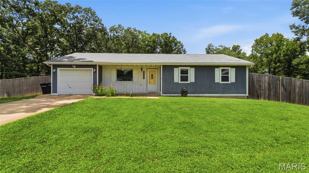Discover the perfect blend of modern updates, outdoor space, and everyday convenience in this beautifully refreshed 3-bedroom, 2-bath home just outside of Waynesville. Situated on approximately 0.8 acres, this property offers the peaceful feel of country living while remaining just minutes from the West Gate of Fort Leonard Wood, making it an ideal choice for military families, commuters, or anyone seeking extra room to enjoy.

Step onto the inviting covered front porch and imagine quiet mornings with a cup of coffee or relaxing evenings watching the sunset. Inside, you'll find a warm, welcoming interior featuring updated laminate flooring, stylishly renovated bathrooms, and a beautifully refreshed kitchen complete with butcher block countertops that add character and charm. Every update has been thoughtfully designed to create a move-in-ready home you'll love from day one.

The outdoor living space is just as impressive. A spacious deck overlooks the expansive, fully fenced backyard, providing the perfect setting for weekend barbecues, entertaining friends, letting pets roam freely, or simply enjoying the privacy and open space. With nearly an acre of land, there's plenty of room for gardening, play, or future outdoor projects.

If you've been searching for an updated home with a large yard near Fort Leonard Wood, this property checks all the boxes. Don't miss your opportunity to own this exceptional Waynesville-area home—schedule your private showing today before it's gone!