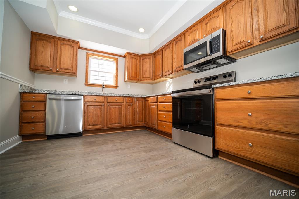 Discover this peaceful, 1.5-story home featuring 3 spacious bedrooms and two bathrooms. The property has been recently updated with fresh paint throughout. Luxury vinyl plank (LVP) flooring has been installed on the first level, offering both durability and style. The upper level features new carpeting, providing comfort and a modern touch, the property is move-in ready, offering a perfect blend of comfort and style for your next chapter. Completing the home’s appeal is a spacious, detached two-car garage—oversized to provide abundant room for vehicles, storage, or hobby space.