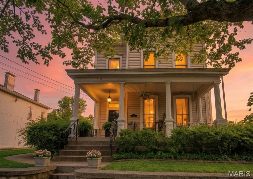 There is a distinct moment when a house becomes a story—and it begins the instant you arrive at the entrance of this peaceful, exclusive bluff top road high in Alton’s highly desirable Christian Hill Historic District. Perched gracefully on the hill, this large Victorian home welcomes you with an unmistakable feeling of timeless magic. Step onto the front porch, take a seat on it’s lovely swing, and let the quiet settle around you. Here, crisp river breezes carry the fresh, unmistakable scent of the Mississippi River, located just a short three-minute walk down the tree-lined sidewalk of this brick paved street revealing a panoramic vista. It is a setting made for slow morning coffees, golden-hour conversations, and building a beautiful, cherished life.

Enter into a realm of craftsmanship rarely seen today. Sunshine filters through numerous stained-glass windows, painting soft jewels of ambient light across rich, hardwood floors that stretch across the entire first floor. Archways guide you seamlessly through a layout designed for both quiet reflection and joyful gathering. A front family room with fireplace flows into a cozy living room with its 2nd fireplace and an adjoining formal dining space crafted for unforgettable dinner parties. At the center of daily life sits the beautifully modernized kitchen—with solid granite countertops, a central island with seating for 4, and a sun-drenched built-in breakfast nook where you can sit and gaze out over the manicured garden.
Upstairs, the home continues to unfold like chapters in a favorite book. A third family room offers a quiet sanctuary for evening movie nights or peaceful afternoons. Tucked just off this space is an office nook, complete with floor-to-ceiling bookshelves waiting to house your favorite literature and treasures. With three bedrooms and two-and-a-half bathrooms, every corner balances Victorian details with effortless daily comfort. Down below, a partially finished basement features a flexible recreation room with a direct walk-up exit to the back patio.

Beyond its romantic soul, the home offers  peace of mind. Thoughtfully updated where it matters, the residence features a modernized electrical system, new blinds throughout, fresh paint, a whole-house water filtration system, a furnace-integrated dehumidifier, and brand-new gutters complete with protective gutter guards.

Stroll out to the backyard to discover your own private outdoor haven. The lush, multi layered garden encircles an expansive patio anchored by a pergola—an outdoor dining area that comfortably seats twelve guests under the stars. 
A long, sprawling driveway provides generous off-street parking for three additional vehicles, leading to a detached two-car garage equipped with a smart attic pulley system for effortless seasonal storage.

This is more than a home; it is a rare piece of architectural history high on the hill, where beauty and modern convenience blend in complete harmony, with the river as it’s siren. This is a story worth reading and deciding if it’s your next chapter ..

Some pictures are digitally staged for you to dream.

Schedule your private tour today!

Saturday, 1-3PM.