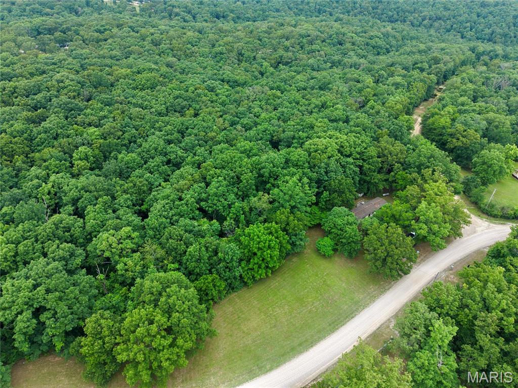Quiet living in a small neighborhood in the woods. This property offers room to build a dream home, cabin, or add to the existing property for additional income if desired. 5+/- acres ready to enjoy!