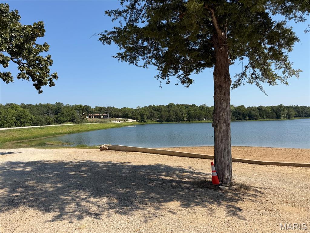 Lake Community Cabin! This property is located in Cedar Lake about an hour south of St Louis. Spend time with family and friends boating, swimming and fishing!  This 2 room getaway has a full bathroom, kitchen area, water, sewer, 200 amp electric box and includes a RV hook up. Needs some TLC and updating.