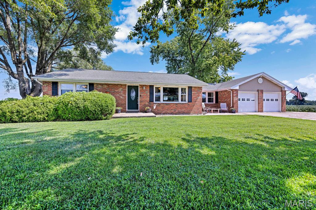 Looking for country living without giving up all the conveniences of civilization? Welcome to 4915 Tower Line Rd! Tucked among beautiful farm fields, this expanded 2-bedroom, 1-bath home gives you the peaceful, wide-open feel you’ve been craving, while keeping you just minutes from Historic Downtown St. Charles, Boeing, New Town, the Katy Trail, shopping, restaurants, and major highways. And yes, if owning chickens has always been on your wish list, you can check that box here!

Inside, there’s room to spread out and gather. The kitchen, breakfast room, and dining room flow together with plenty of space for entertaining. In fact, there’s enough room for a holiday table stretching more than 25 feet, so bring on Thanksgiving! The updated hall bath features a beautiful quartz countertop, adult-height vanity, and easy step-in shower.

Head downstairs to the partially finished walk-up basement, where you’ll find a comfortable family room plus a bonus room currently used as an office. The unfinished area houses the laundry and utilities, along with an enclosed freestanding shower that comes in handy after gardening, woodworking, muddy adventures, or whatever else you get into. The washer, dryer, water softener, and Whirlpool garage refrigerator can stay with the home.

There’s also plenty here to make homeownership a little easier. Recent updates include PEX water lines, PVC waste lines, a high-efficiency gas furnace and AC installed in 2025, gas water heater from 2022, 200-amp electrical service, and 100-amp subpanels added in 2019 to both garages.

The outdoor spaces are where this property really shines. The large covered patio just off the kitchen and walk-up basement is made for morning coffee while watching the sunrise over the fields, lazy summer dinners, and relaxing at the end of the day. The yard is peaceful and private, with mature shade trees and established garden beds ready for your green thumb. There’s a charming front patio for evening cocktails under the stars, plus another patio near the sheds that gives you even more room for entertaining or working on your latest project.

And speaking of projects…you’re going to LOVE the garage space! There’s an attached 22x20 two-car garage PLUS a huge 29x20 detached garage currently set up as a workshop. Cars, woodworking, hobbies, equipment, storage, man cave, she shed, small business…you’ve got options! There are also two metal sheds, including one converted into a wood kiln for producing seasoned firewood and cleaner-burning fires. The seller-owned propane tank is another great bonus.

A few important details: the property is located in a flood zone, and flood insurance is required. However, the current owners have lived here for 13 years and the property has NEVER FLOODED, including during the Great Flood of 1993.  Located in the award-winning Orchard Farm School District and just one mile from the Katy Trail, this is country living with a very convenient side. Historic St. Charles, New Town, shopping, dining, Boeing and major highways are all close by, and the brand new Dierbergs in nearby New Town opened August 18.  

If you’ve been dreaming about a little more land, a little more breathing room, room for your hobbies, and maybe even a few chickens, this one is worth a look.  Don't Sleep on Your Dream Home, Sleep in It!!  OPEN HOUSE SUNDAY Aug. 30th from 1-3pm.