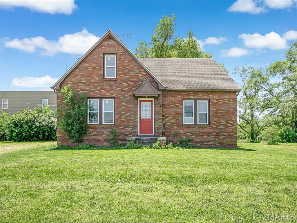Welcome to this charming brick Tudor-style home situated on approximately 1 acre in a convenient location! Full of character and timeless appeal, this 3 bedroom, 1 bathroom home offers a blend of original craftsmanship and modern updates. The spacious living and dining areas feature updated flooring, arched openings, and abundant natural light throughout. The kitchen offers ample cabinet and counter space along with a movable center island and stainless steel refrigerator. Upstairs you’ll find additional bedrooms with beautiful original wood trim and generous closet space. Outside, enjoy the large yard, mature trees, detached garage, and plenty of room to expand, entertain, or simply enjoy the outdoors. Whether you’re looking for a primary residence, rental property, or investment opportunity, this property offers tons of potential with solid curb appeal and classic charm.