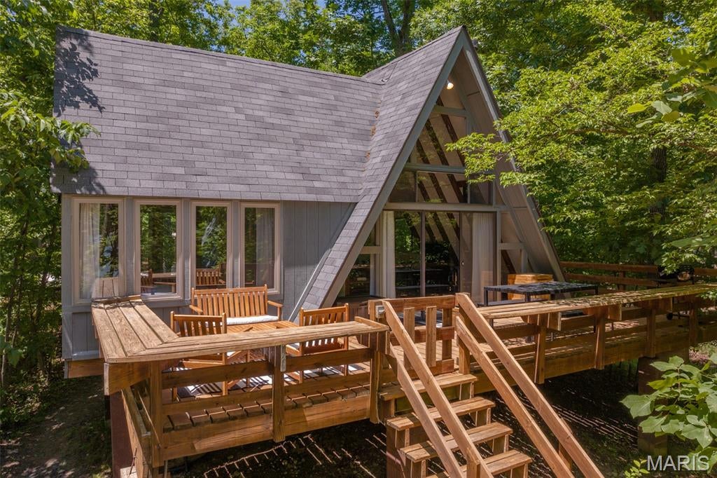 Recently renovated lakefront Chalet, set on a level lot with an easy walk to the shores of 8-acre Lake Audubon. Offered as a fully furnished, turnkey short-term rental with an established booking history and consistently strong 5-star guest reviews. Oversized windows frame water views from nearly every room, while the open-concept living area features a wood-burning stove and sliding doors to an expansive back deck. The updated kitchen showcases custom cabinetry and quartz countertops, fully equipped for effortless entertaining. A versatile loft adds bonus sleeping space and a home-office nook above the main living level. The primary bedroom offers a queen bed and elongated windows with year-round lake views; the loft sleeps additional guests with a king and two twins for a total capacity of 6. New flooring, fresh landscaping, and thoughtfully curated furnishings complete the recent renovation throughout this retreat. Outdoor living is the showpiece: a private dock, four kayaks, a hot tub, gas grill, and a dedicated fire pit area create a true resort-style escape just steps from the water. Ideally located near the Innsbrook Golf Course, Clubhouse Bar & Grille, and Aspen Center, with access to all Innsbrook amenities — pools, lazy river, tennis and pickleball, hiking trails, and more. Sold fully furnished and rental-ready, Casa del Lago is a proven income-producing second home or investment property for a buyer seeking immediate cash flow potential in one of Innsbrook's most sought-after lake settings.