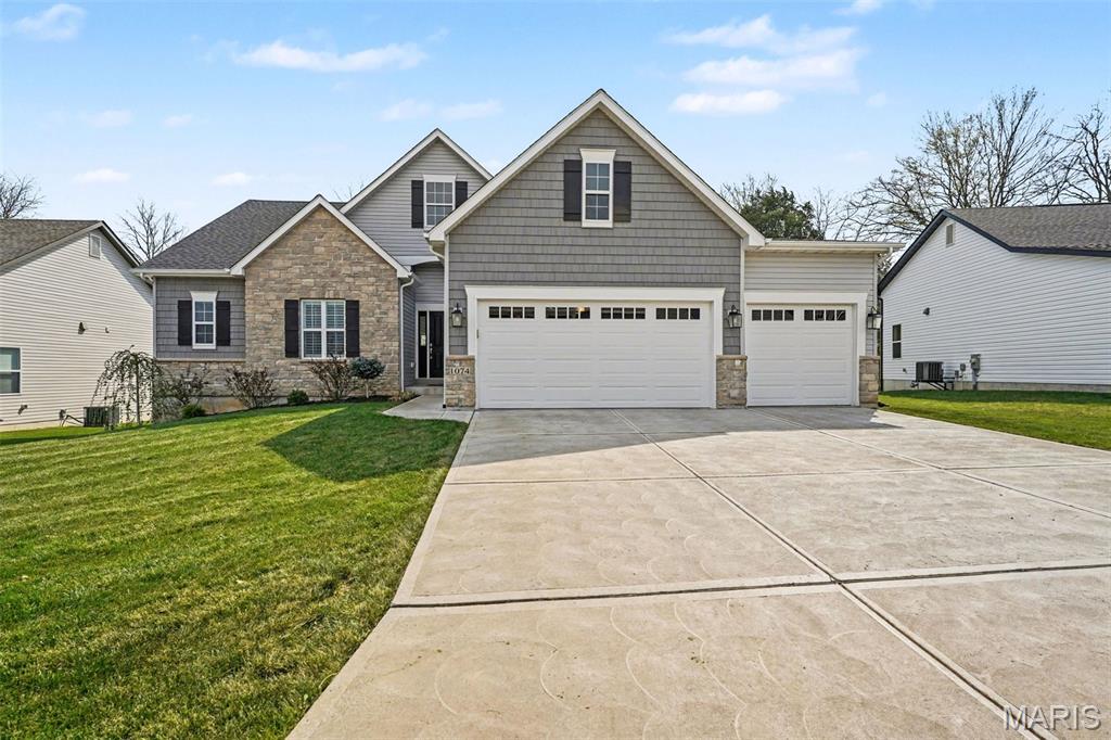 Welcome to this beautifully maintained custom-built 3 bed, 2 bath ranch home built by Flower & Fendler, offering 2,317 sq ft of thoughtfully designed living space. The open floor plan features a spacious kitchen and great room with 12’ ceilings, creating a bright and inviting space perfect for everyday living and entertaining. The gorgeous kitchen showcases custom cabinetry, quartz countertops, a large center island with seating, stainless steel appliances, and a gas range, along with a walk-in pantry. Just off the main living area, the hearth room with fireplace adds a cozy second gathering space. The primary suite offers a private luxury retreat with a double vanity, walk-in shower, and an upgraded walk-in closet system. Two additional bedrooms and a full bath provide plenty of space for family or guests. Main floor laundry adds everyday convenience. The partially finished lower level includes a rec room with a bar countertop, offering additional space that’s perfect for entertaining, relaxing, or hosting guests, with plenty of potential for future expansion. Step outside to enjoy a beautifully enhanced backyard featuring a patio, landscaping, irrigation system, and a fully fenced backyard, perfect for relaxing or entertaining. Additional upgrades include plantation shutters throughout, updated lighting, and an EV charger in the oversized 3-car garage.
Located in the desirable Rockwood School District. Don’t miss your chance to make this beautifully upgraded home yours!