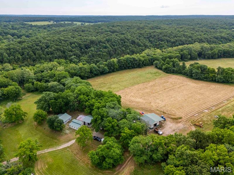 Property Description for Tract 1: 478.4± Acres
The ground rolls through hardwood ridges and brushy bedding cover, with acres of food plots laid out across the ranch in varied plantings. Hyde Creek, a rock-bottom Ozark stream, horseshoes through the heart of the property and cuts through several other sections, giving wildlife year-round live water and a natural travel corridor. Multiple springs feed the creek and keep water on the ground through the dry months. Deer and turkey numbers are as strong as anywhere in this part of Missouri, the product of long-term habitat management, food plots, and natural thickets that hold fawning does and nesting hens. Quail are also on the property and have grown in number each year. The current owner does not hunt them.

Hunting infrastructure is in place and built to last. Box stands sit across the ranch positioned over food plots and high-traffic timber funnels. A well-maintained interior and perimeter trail system ties the whole ranch together, allowing quiet access to and from every stand. Building those roads was no small job, and the result is a property that hunts as easily as it looks on a map.

The cabin is a 30x30 one-bedroom, set back off the road in a quiet spot where deer and turkey work the edges most mornings. A portable building with an addition adds four more beds and a full bath enough room for a full hunting camp. An old 30x30 barn has been converted into a cooking and gathering space with a pellet fireplace and kitchen, opening onto a 30x30 covered slab with a TV. Good place to watch a game, run the grill, and keep an eye on the nearest food plot.

A 30x40 metal shop sits on a concrete slab with a 14-foot lean-to down one side, plenty of room for equipment, side-by-sides, and gear. All of the front buildings are wired and backed by a 20 kW Cummins diesel generator on an automatic transfer switch. Lose power, and the hunt and the stay keep right on going.

The ranch is about 55 minutes from Springfield and roughly an hour and a half from Branson, with the Springfield-Branson National Airport, hospitals, and any supplies you might need within an easy drive. Hartville anchors the area with its historic courthouse square, and the Mark Twain National Forest, Bennett Spring trout waters, and the central Ozark float streams are all within reach for anyone looking to get off the property.

Burke Ranch is turnkey. Large contiguous acres of timber, water, food plots, and ready to hunt. Properties built like this don’t come along often. Come walk it and see for yourself.

“Property & structures are being sold as is/where is.  Seller will make no repairs. Buyer may opt to have inspections conducted for informational purposes only”
