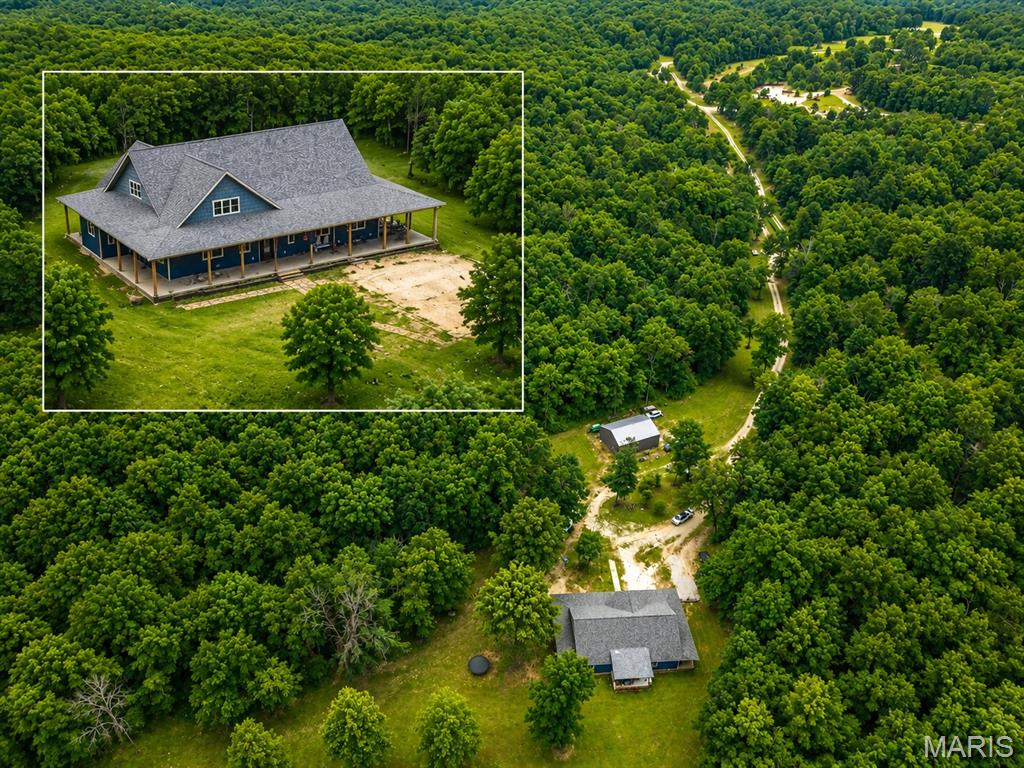Custom Home with park-like setting on 50+ acres. Located in the heart of the Ozarks. Located between West Plains, MO and Mountain Home, AR. Approx 4-Bedroom, 2.5 bath. Geothermal heating and air. Open Concept Floor Plan with 20'+ceilings. The kitchen has stainless-steel appliances and a breakfast bar. Plus another bar for cooking, canning, lots of storage, plus a walk-in pantry and a separate butler's pantry. Storage. Laundry Room and half bath for you convenience, The primary bedroom has a large primary bath, with a soaking tub and a large walk-in tile shower. Separate sinks and a walk-in closet the size of another bedroom. Also walks out to the covered back patio, Office or 4th bedroom on this end of the home. Two bedrooms and main bath on the other end. Wrap around over 1300 sq.ft of covered concrete patios. 30x40 shop with concrete, floor and electric. 200 amp with 220 electric. Electric garage door openers. 14' high with the doors 12'. RV Hook-up. Storage shed. Surrounded by an abundance of wildlife.