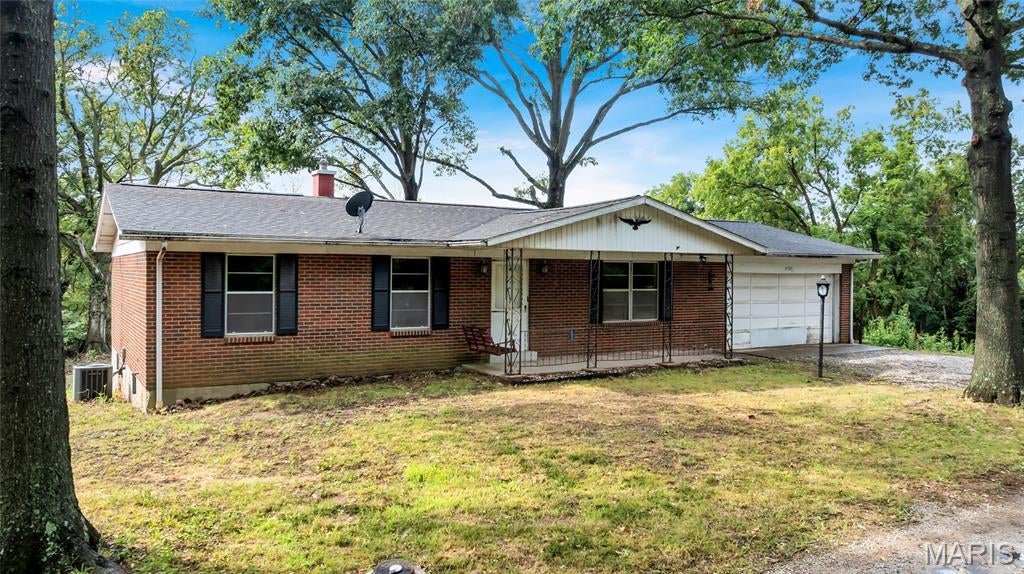 A rare opportunity to own over 9.5 private, wooded acres just outside of Columbia! Surrounded by mature trees and offering exceptional privacy, this brick ranch is filled with potential for the buyer ready to make it their own. Vintage details throughout give the home plenty of character, while its solid footprint provides an excellent starting point for renovation and the opportunity to build significant equity.

The main level features three bedrooms, including a generously sized primary suite with private bath, a spacious kitchen, attached garage, and a large sunroom overlooking the peaceful wooded setting. The unfinished walkout lower level offers abundant storage, a convenient half bath, and additional possibilities for future living space.

Outside, the expansive acreage provides the space and seclusion that are increasingly difficult to find, while an enormous detached shed offers outstanding storage for equipment, recreational vehicles, hobbies, or workshop space.

This home is ready for renovation and priced with its condition in mind, making it an exciting opportunity for an owner-occupant, investor, or anyone searching for an affordable way to create their dream property on acreage. With more than 9.5 wooded acres, tremendous storage, privacy, and room to add value, the possibilities here are hard to match.
