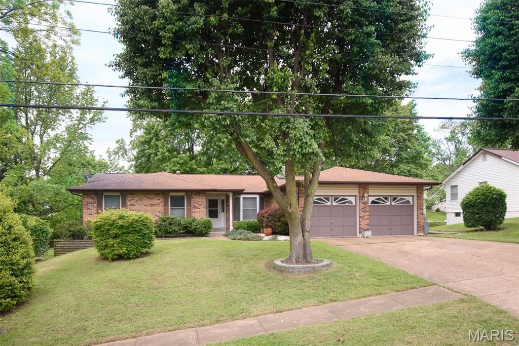 Hidden Gem in Bridgeton, MO! 3 bd 3 ba Ranch, open floor plan with vaulted ceilings, dual skylights, & plant shelf. Main floor laundry, 4 seasons sunroom off the eat in kitchen with bay window, that could easily double as a home office. Kitchen has newer granite countertops with lots of cabinet space and large peninsula island. Large primary suite with walk-in closet, en-suite bathroom has soaker tub, & separate shower. Woodburning fireplaces on main and lower levels, Large entertaining/recreation space in the walk-out (new patio door 7/26) basement with large bar, full bath, and extra sleeping room. Outside this almost half acre level lot boasts a 2nd driveway with a fenced in back yard and an additional 2 Story 28x40 RV garage for the car or travel enthusiast. This home has already passed the required Bridgeton occupancy and is ready to move in!