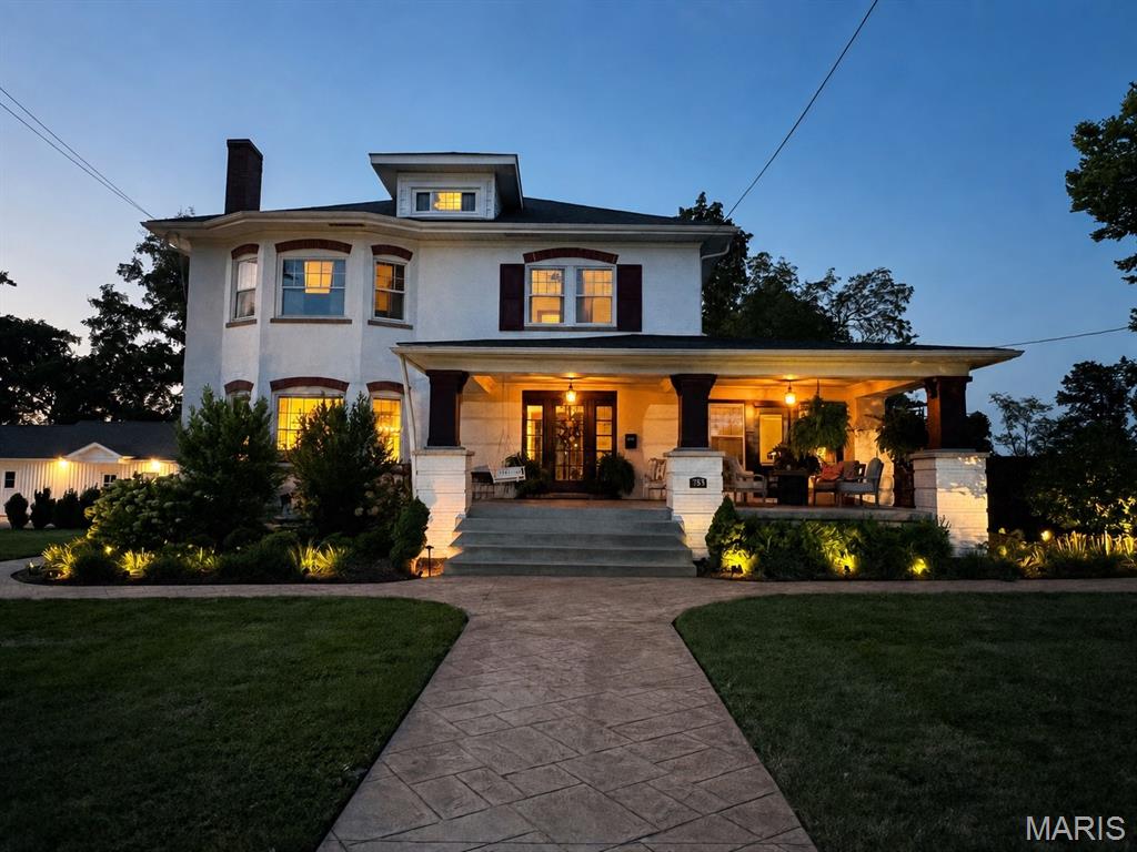 A rare treasure near downtown Troy, this distinctive 1909 home blends timeless character with an extensive five-year, top-to-bottom renovation. A newly rebuilt deep covered front porch welcomes you into an interior filled with hardwood floors, substantial millwork, solid wood doors and beautifully preserved architectural details. The inviting living room features a coffered ceiling and decorative fireplace, while the window-filled brick sunroom offers an ideal office, reading room or additional gathering space. The completely remodeled kitchen pairs new white cabinetry and stone countertops with a generous island, stainless appliances, exposed beams, new lighting and striking herringbone brick flooring. Additional improvements include new wood flooring and carpeting, a remodeled primary bath, new first-floor trim, fresh interior and exterior paint, geothermal HVAC and a replacement PVC sewer line extending from the home to the street. Outside, enjoy a private retreat featuring an approximately 1,500-square-foot paver patio, three-year-old above-ground pool, hot tub, outdoor fireplace and grilling area, new sidewalks, exterior lighting, privacy fencing and extensive new landscaping. The park directly behind the home creates a gorgeous borrowed landscape with seemingly endless green views—without the maintenance or property-tax burden of owning the additional acreage. The former oversized four-car garage has been transformed to include two spacious one-bedroom, one-bath apartments, each with its own laundry, plus a dedicated gym. Currently used for family, these spaces provide exceptional flexibility for extended family, guests, private offices or creative pursuits. Covered parking, multiple outbuildings and abundant driveway space complete this truly one-of-a-kind property.
