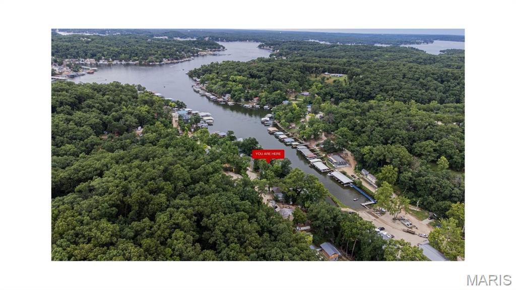 Lakefront living at its best! This 4-bedroom, 1.5-bath home offers 82 feet of waterfront frontage and is located at the 6-mile marker, just off the main channel and conveniently close to the dam. The home features a walk-out basement, providing easy access to the outdoors and additional living or storage space.

Enjoy the private dock with a fully equipped electric boat lift and a spacious slip measuring 26 feet deep by 16 feet wide. An additional 6-foot overhang provides the perfect space to tie up a second boat. Whether you're looking for a weekend getaway, investment property, or full-time lake home, this property is ready for you to enjoy everything the Lake of the Ozarks has to offer.