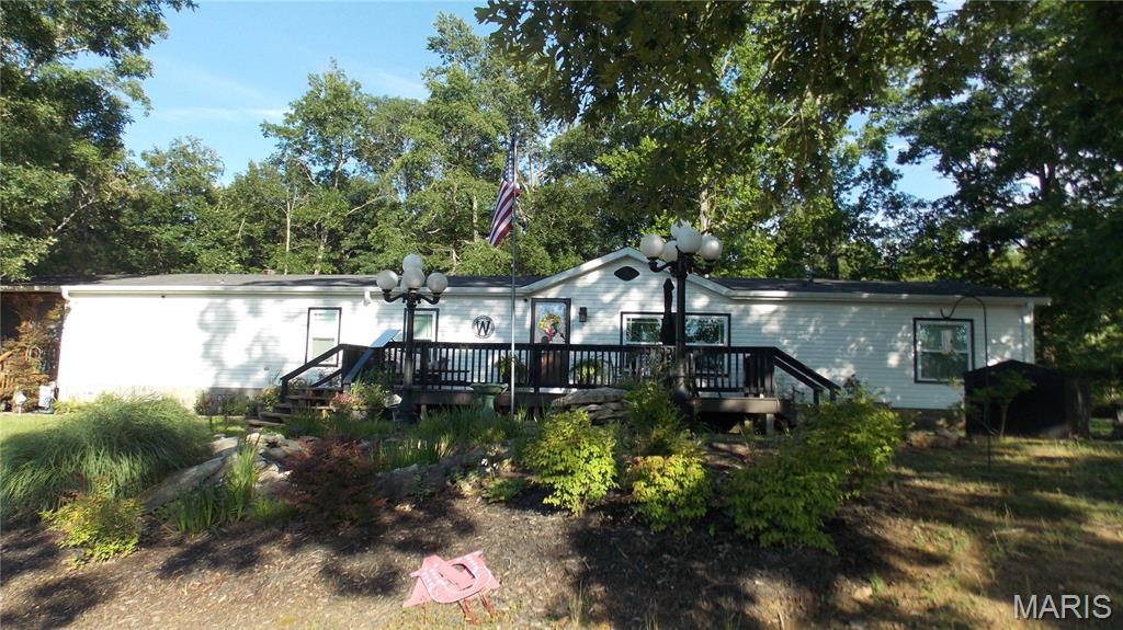 3 bedroom 2 bath manufactured home in one acre with raised garden , 20x36 detached garage , also a storage shed , large covered deck with screening perfect sitting area with views, hone has family room with gas log fireplace, kitchen with granite top island and butcher block countertops, walking pantry, spacious room sizes, tastefully decorated with front deck and small deck off breakfast area, dining room, koi pond