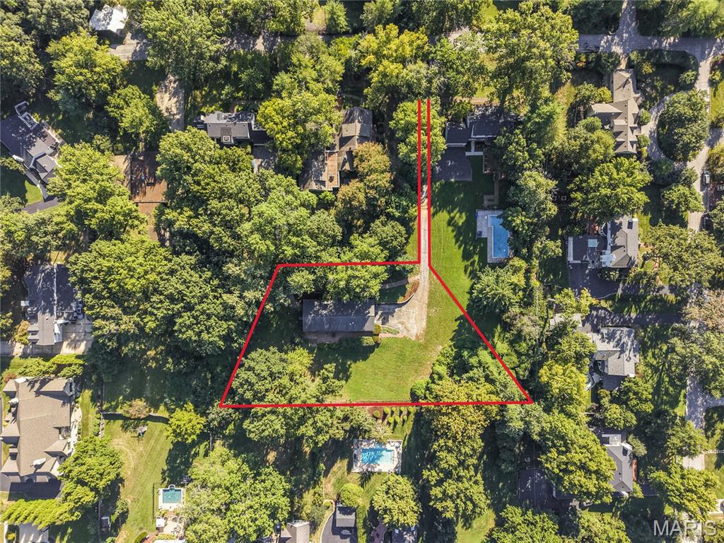 The perfect opportunity to build. Located in the heart of Ladue, and in coveted Reed Elementary School.  Sitting on a pie-shaped lot that fans broadly out in the back, the parcel is just shy of a full acre (.93) on a very rare flag lot ( a long drive leads to the residence and lot completely hidden from the street and one that offers the height of absolute privacy) the buildable space sits far back off Graybridge Road, located adjacent to the Saint Louis Country Club off Ladue Road. New homes in the immediate vicinity have values and resales, up to $4M+, creating limitless options for design, and style.  A reserved and serene setting, awaiting vision for its next page of stewardship. Currently a 1 story home sits on the property. It is gutted to the studs and should not be considered as a residence with restoration potential. Lot lines rendendered in photos are approximate and should be confirmed with a survey.