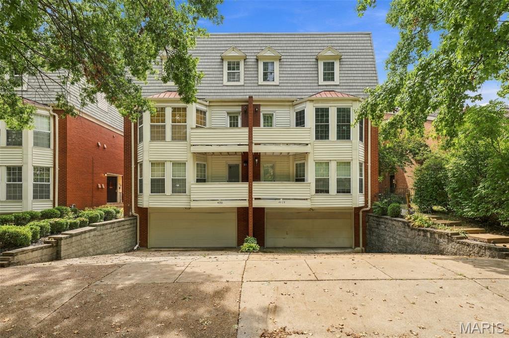 Welcome to this charming condo in the historic Central West Ed neighborhood! This beautifully updated 3-bedroom condo is within walking distance to all the amazing restaurants, entertainment and shops! Minutes away from WashU Medical Campus, Barnes, WashU, Children's Hospital & Forest Park. As you enter, you will love the open floor plan w/ tons of natural light and newer hardwood floors throughout. Spacious living room with gorgeous wood-burning fireplace. Updated kitchen with breakfast bar, granite countertops, stainless-steel appliances  and custom cabinetry. Dining room area leads to private balcony space-perfect for morning coffee or evening wine. Updated half bath. Upstairs you will find a spacious primary bedroom with walk-in closet & additional living room space, 2 additional bedrooms (one with private balcony) and full bath with double sink. The community pool is just steps away- your personal oasis for relaxation and leisure! Fenced in backyard space is perfect if you have pets or are just looking for a private backyard space. In unit laundry in basement with one car garage.