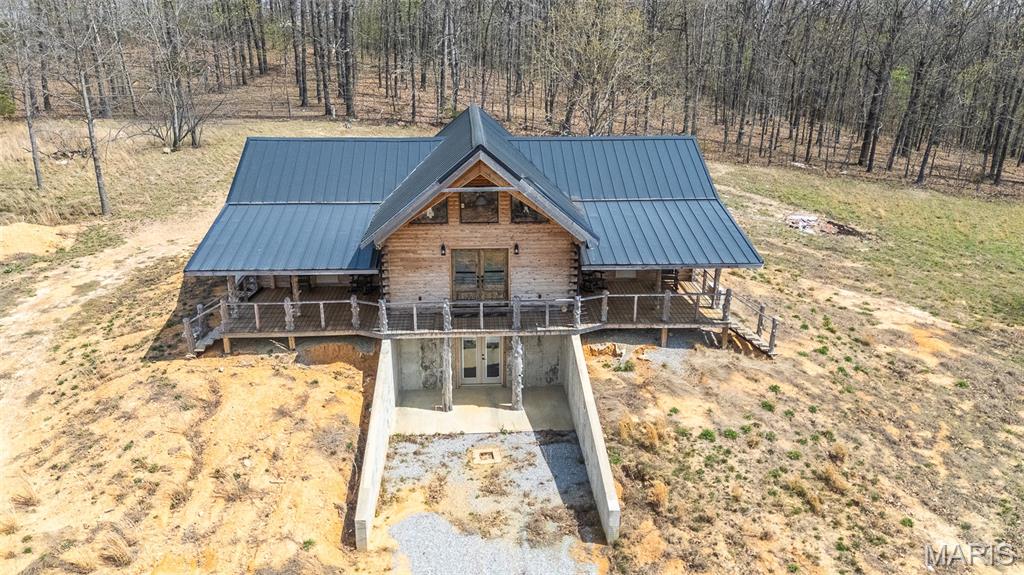 Absolutely stunning cedar log home with a breath taking view of God's Country! Five acre tract tucked back in off of a county road with plenty of privacy but less than 15 minutes from Doniphan and even quicker to public access to gorgeous Current River. This home was just built and the owner had some of those unexpected life events that changed their plans. Work is still being completed on it, but it is move-in ready! You have two beautiful bedrooms and baths on the main floor with a loft bedroom with a view you won't believe. Beautiful wood everywhere! Stylish designer kitchen with stainless appliances and custom counters and cabinets. Basement is ready for your choice of bedroom, game room, man cave, or whatever with plumbing stubbed in for downstairs bath. Main floor consists of 1584 sq feet and basement is 640 sq feet. The home is built to enjoy the view with two outside seating areas, plus a back deck, and a back screened in seating area. Lots of places to enjoy the sunrises, sunsets, or just to watch the wildlife as the deer frequent the area in front of the home. The owner built this as their dream home. But are ready to allow you to take it from here and make it all yours.