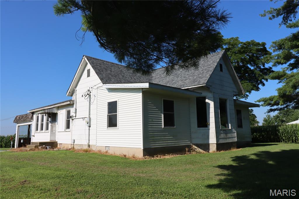 Enjoy country living in this charming two-bedroom two bath home. Home has large rooms, formal dining room and Hardwood floors. Enclosed Porch area could be used for extra living space or third bedroom.  With an attached carport, a detached two-car garage, and a partial basement, this property offers convenience, storage, and room to make it your own.