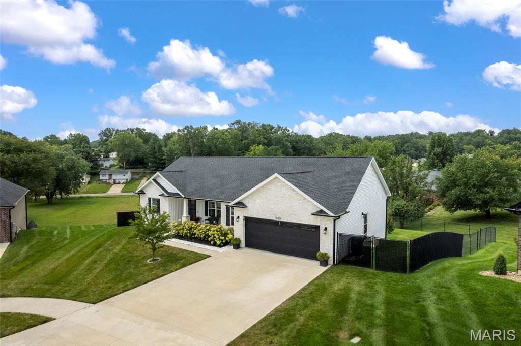 Built just four years ago, this beautifully maintained 4 bedroom, 3 bathroom home offers the perfect combination of design, functionality, and outdoor living. Located in a quiet neighborhood just minutes from schools, hospitals, shopping, and other everyday conveniences, you'll enjoy both peace and accessibility.
The open concept main level creates a bright, welcoming space for everyday living and entertaining. Just inside the garage entrance, a convenient drop zone with built in cubbies keeps backpacks, shoes, and coats neatly organized. The spacious kitchen flows seamlessly into the living and dining areas, making it easy to gather with family and friends.

The private primary suite provides a relaxing retreat with generous space and a well appointed en suite bath. Downstairs, you'll find a large family room perfect for movie nights, game days, or a play area, along with abundant storage and a John Deere room for lawn equipment, tools, or hobbies.

Outside, mature landscaping enhances the home's curb appeal, while the covered deck overlooks a fully fenced backyard, creating the perfect place to relax, entertain, or enjoy time with family and pets.

With modern construction, a functional floor plan, generous storage, and an unbeatable location, this move in ready home is one you won't want to miss.