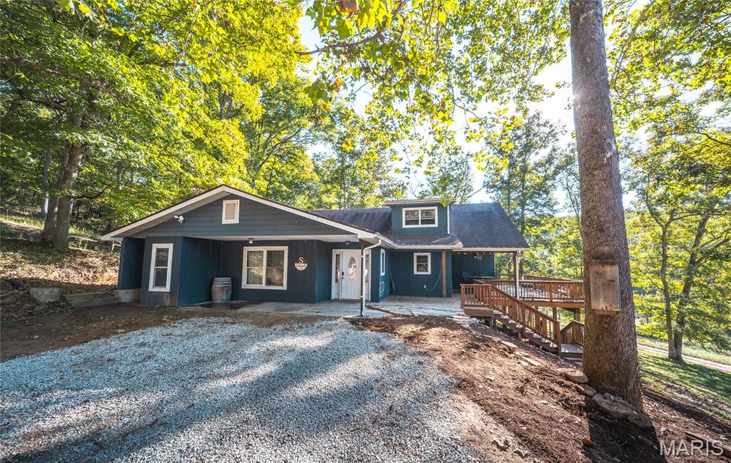 This lovely one-and-a-half story home is nestled in the woods on a generous 8.09-acre lot, offering privacy & natural beauty. With approximately 3,000 sq ft of living space, this property boasts 4 beds and 2 baths, making it ideal for comfortable living. The main floor is thoughtfully designed & includes an eat-in kitchen w/ample storage, a spacious DR perfect for entertaining, & a cozy living room featuring a wood-burning fireplace. Additionally, this level offers a dedicated office, utility room, 2 comfortable bedrooms, and a full bathroom. Upstairs, you'll find 2 large bedrooms, another full bathroom, & a versatile sitting or study area, providing plenty of flexible space. The partial walkout basement is currently set up as a workout and rec area, along w/addl storage space. The outdoor amenities are equally impressive. You can relax on the covered deck which is large enough to accommodate family & friends. This property offers so much to explore & enjoy in its natural surroundings.