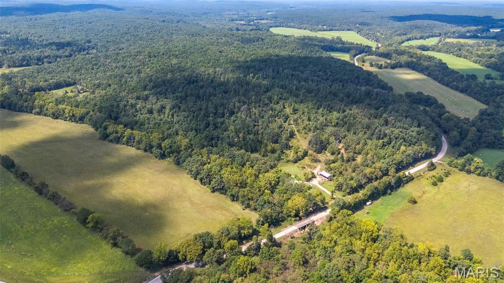 Just in time for deer season 140 +/- acres of beautiful farm ground with highway frontage! 40 +/- acres of pasture ground, 100 +/- acres of woods,  live springs, all-weather creek, 2 old farmhouses with electric on the property, and a old storm shelter. This place could make an excellent starter farm and/or hunting property. It's full of wildlife making it a deer hunters paradise. This place has the most beautiful scenery,  which makes it a must see.
Property line in the last photo are approximate.