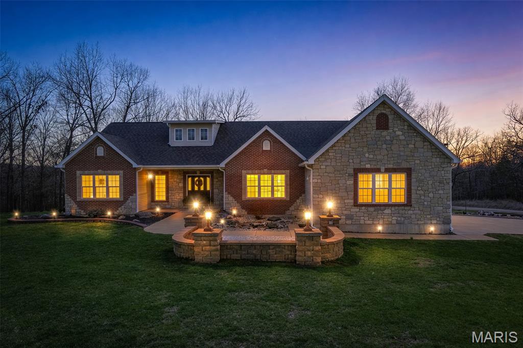 Located in a sought after development, this quality built - 5 bedroom-3 bath home offers over 4,000 sq ft of living space designed for comfort and entertaining.
Step inside to a large, welcoming entry that leads to beautiful hardwood floors and spacious living areas throughout.  The home features a gas-burning fireplace, creating a warm and inviting atmosphere.
The full walk out basement includes a gorgeous custom bar, making it ideal for hosting gatherings.
Outside, enjoy your own custom patio and outdoor fireplace. All set on just over 4 beautifully landscaped acres. The extensive landscaping and generous lot provide both privacy and beautiful surroundings.
