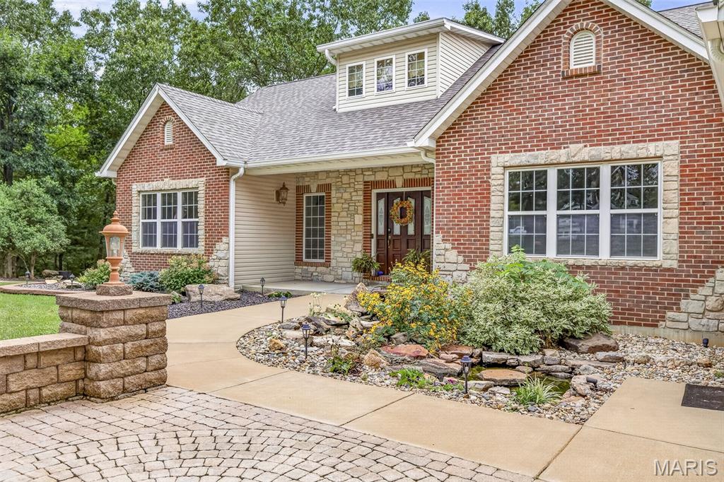 Located in a sought after development, this quality built - 5 bedroom-3 bath home offers over 4,000 sq ft of living space designed for comfort and entertaining.
Step inside to a large, welcoming entry that leads to beautiful hardwood floors and spacious living areas throughout.  The home features a gas-burning fireplace, creating a warm and inviting atmosphere.
The full walk out basement includes a gorgeous custom bar, making it ideal for hosting gatherings.
Outside, enjoy your own custom patio and outdoor fireplace. All set on just over 4 beautifully landscaped acres. The extensive landscaping and generous lot provide both privacy and beautiful surroundings.