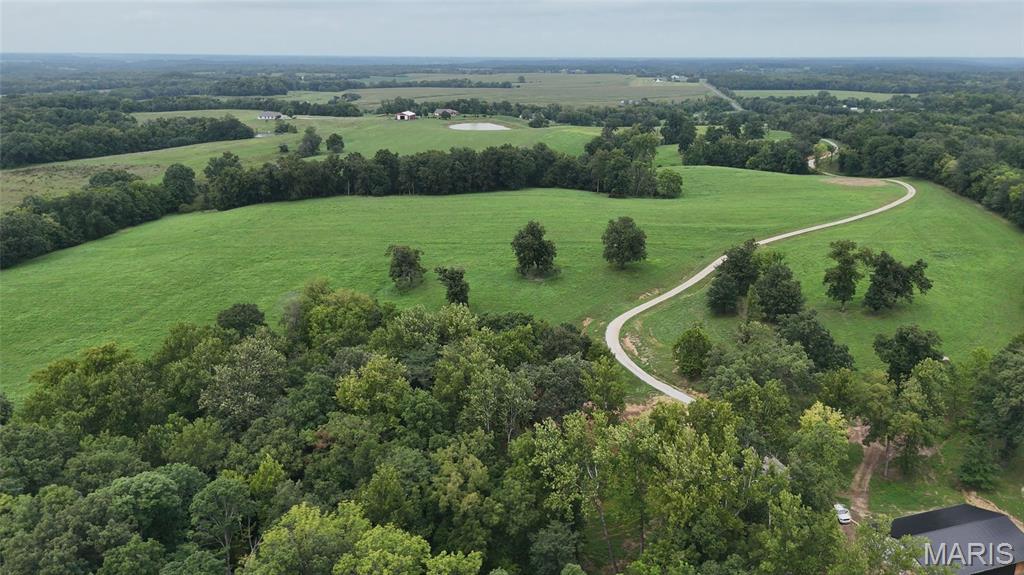 75+- acres | Private Rural Estate with New Shop, Barn, Pond & Underground Utilities

This versatile 75+- acre property offers an impressive combination of beautiful views, quality improvements, productive acreage, excellent hunting, and privacy. Conveniently located between Monroe City, Palmyra, and Hannibal, the property has been meticulously maintained for more than 20 years and is ready for its next owner.

A half-mile private drive leads to the back of the property to a newly constructed 48’ x 72’ building. Built with quality and durability in mind, it features 12-foot ceilings, 2x6 framed walls, upgraded 26-gauge roofing/trim, a radiant barrier, 6-inch concrete floors with full footings, additional rebar, and fiber reinforcement. Rough-in plumbing is in place for a bathroom, multiple sinks, and spigots, with interior framing underway for several rooms. A half-mile of underground electric, water, and high-speed fiber has also been ran to the building. Whether used as a workshop, business headquarters, hunting retreat, or future residence, the building offers outstanding flexibility with room to expand.

The property also includes a 50’ x 72’ pole barn with 14-foot sidewalls and two 16-foot sliding doors providing excellent storage for equipment, hay, livestock, or recreational vehicles.

Everyone will appreciate the 1.5-acre pond stocked with catfish and bluegill, along with excellent deer and turkey hunting. The property backs to Sees Creek and has been carefully managed to provide quality wildlife habitat throughout.

With approximately 35–40 acres estimated to be tillable, the land is currently being used for hay production yielding approximately 130 large round bales per cutting without fertilizer application.

Rolling terrain provides beautiful views and numerous potential building sites. With utilities already in place, the property is well-suited for division into multiple tracts, adding further potential. The entrance is just 100 yards from blacktop on a quiet quarter-mile dead-end county road shared by only three neighboring homes. Mark Twain Lake is just 12 miles away!

Whether you’re seeking a private country estate, hunting retreat, productive farm, business location, or long-term property, this acreage offers a hard-to-find combination of infrastructure, recreation, productivity, and privacy.
--
Property Highlights
• 75+- acres
• Half-mile private drive with new underground utilities
• New 48’ x 72’ utility-ready building with upgraded construction and rough-in plumbing
• 50’ x 72’ pole barn
• 1.5-acre stocked pond
• 35–40 acres estimated to be tillable
• Productive hay ground
• Excellent deer and turkey hunting
• Property backs to Sees Creek
• Numerous scenic building sites
• Potential for division into multiple tracts
• Quiet dead-end road with minimal traffic
• 12 miles to Mark Twain Lake