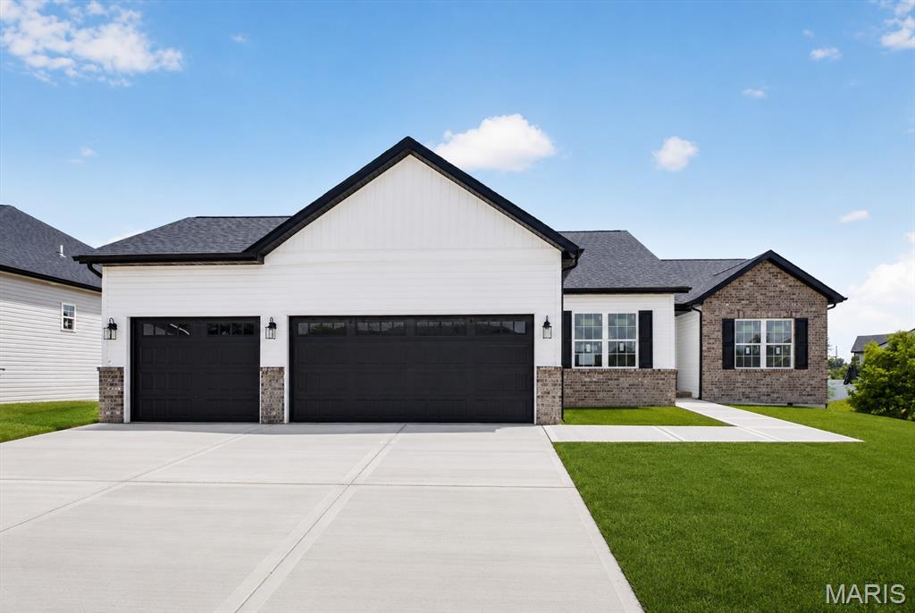 Brand new construction by New Tradition Homes, completely finished and move-in ready now in the newly developed Park Bridge Station subdivision in O’Fallon, Illinois. Conveniently located near Scott Air Force Base, a nearby park, shopping, dining, schools, and major commuter routes.

This spacious 5-bedroom, 3-bath home features an open-concept layout with vaulted ceilings, an electric fireplace, quartz countertops, 42-inch soft-close cabinetry, a large center island, mudroom, and modern finishes throughout. The primary suite includes two closets, while the finished walkout lower level offers additional living space, bedrooms, and flexibility for guests, a home office, recreation room, or additional family space.

Additional features include a 3-car garage, composite deck, finished lower level, builder warranty, and the convenience of purchasing a brand new home without waiting for construction to be completed.

If you are searching for new construction in O’Fallon, Illinois, a move-in-ready home near Scott Air Force Base, a 5-bedroom home with a finished basement, or a brand new home with a 3-car garage in Park Bridge Station, 1227 Ole Town Bridge Drive is ready now.