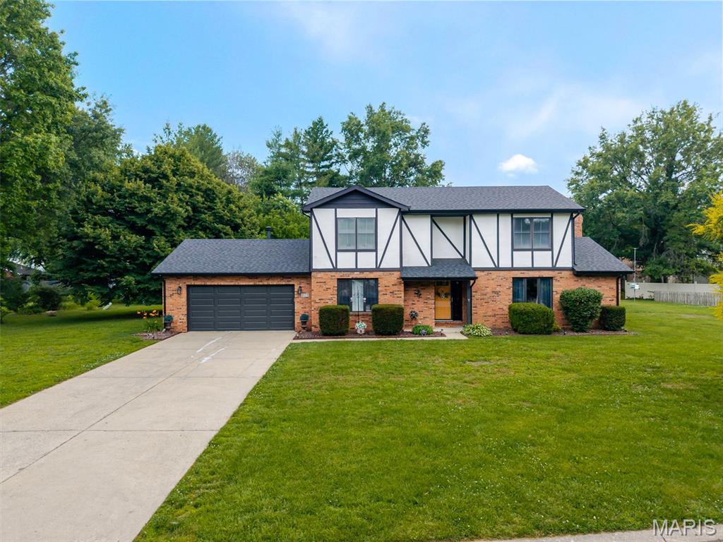 Beautiful 2-story, 3 bedroom/3 bath home with charming Tudor-inspired accents on one of the largest lots in the neighborhood! Located in a quiet, centrally located setting, this well-maintained home offers great space inside and out. The main level features a large living room, formal dining room, and a kitchen that opens to the breakfast room, giving you multiple spaces to gather, relax, or spread out. Just off the dining area, a cozy sitting area with floor-to-ceiling brick fireplace adds extra charm and flexibility, while main-level laundry and a powder room add everyday convenience. Upstairs, the spacious primary bedroom features two closets, including an impressive walk-in closet (10x7), plus a private bath with dual sinks and a tiled shower. Two additional bedrooms and a full guest bath complete the upper level. All closets include installed closet systems for added organization. The oversized garage (23' deep x 21' wide) offers plenty of room for a large truck plus extra storage. Enjoy the massive, semi-private backyard (almost a 1/2 acre) and covered patio, perfect for relaxing, entertaining, or making the most of the extra outdoor space. Nearby Silver Creek Preserve, Clinton Hills Conservation Park and the MetroBikeLink Trail provide great options for walking, biking, and enjoying the outdoors. You’ll also love the convenient access to SWIC (walking distance), shopping, dining, and everyday essentials. Updates include new roof and gutters in 2022, carpet in the formal dining and living room in 2022, and kitchen and flooring updates in 2016. Carpets have been recently cleaned, and caulking and paint touch-ups have been completed. This home has passed municipal occupancy inspection and is ready for its next owner! Just 9 minutes to Scott AFB!