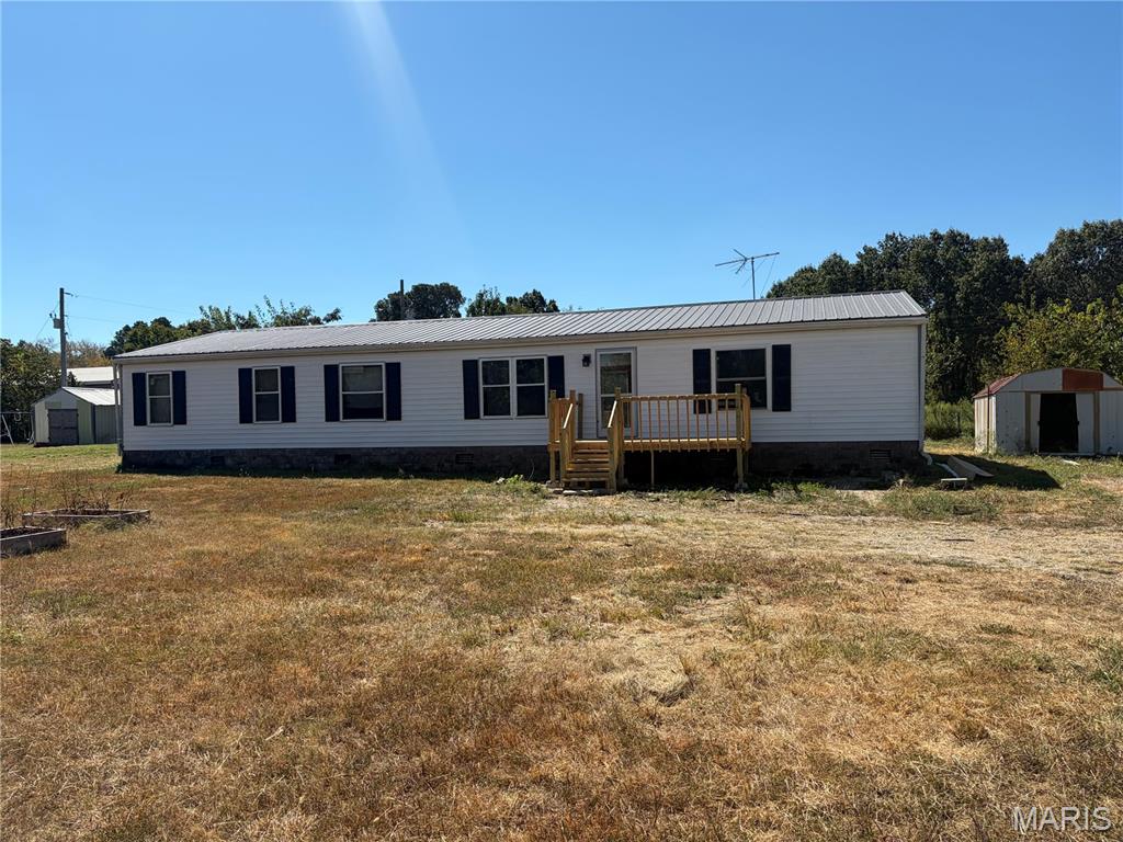 Welcome to this single-story home offering affordable, easy-living potential in Northeast Laclede County! Featuring durable vinyl siding and a traditional footprint, this home is situated in a quiet neighborhood within the highly sought-after Lebanon R-III School District. Inside, enjoy a dedicated fireplace in the dining area—perfect for gathering around during cooler months. The property features a manageable back yard space ideal for pets or outdoor relaxation. Complete with central air conditioning, propane heat, connected electricity, public water, and a septic system.