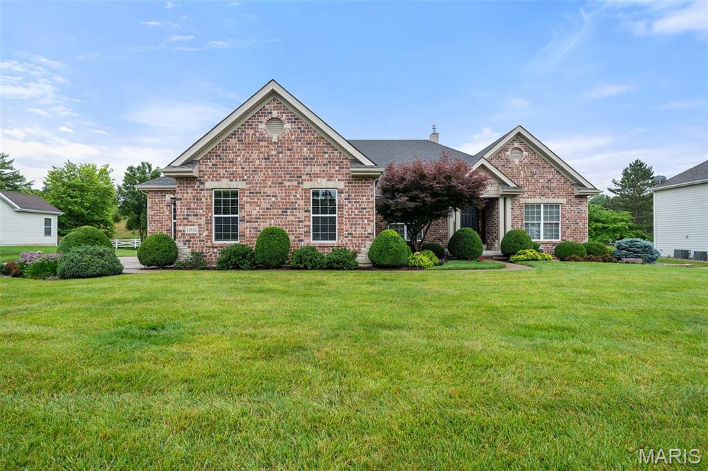 Prepare to fall in love with this stunning brick ranch, where timeless elegance, exceptional craftsmanship, and thoughtful upgrades come together in a home designed to impress. From the beautifully landscaped exterior to the sophisticated finishes inside, every detail has been carefully selected and meticulously maintained.

Step inside and immediately appreciate the dramatic 12-foot ceiling in the great room, complemented by 9-foot ceilings throughout the main level, beautiful hardwood flooring, crown molding, oversized baseboards, custom millwork, and upgraded lighting. The spectacular great room, anchored by a gas fireplace, opens effortlessly to the dining and kitchen areas, creating the perfect gathering space for everything from quiet evenings at home to unforgettable entertaining.

The kitchen is truly the heart of this home and is sure to impress even the most discerning chef. Rich cabinetry, gleaming granite countertops, a breakfast bar, travertine backsplash, double ovens, electric cooktop, stainless-steel appliances, extra-deep double sink, roll-out cabinetry, appliance panels, and under-cabinet lighting combine beauty with exceptional functionality. A newer Bosch dishwasher and disposal add even more convenience. Just off the kitchen, the charming breakfast room features a bay window overlooking the gorgeous professionally landscaped grounds.

For more formal occasions, the elegant dining room delivers with its beautiful tray ceiling, detailed millwork, and open connection to the great room.

Retreat to the luxurious primary suite, where double doors welcome you into a peaceful private escape. The spacious en-suite bath features a soaking tub, frameless pivot shower door, adult-height dual vanity, upgraded cabinetry, and Kohler fixtures. The oversized walk-in closet is beautifully outfitted with custom built-ins. Three additional bedrooms provide generous space for family and guests, while the versatile den—with closet and stunning waterfall-glass French doors—offers endless possibilities as a home office, sitting room, or additional bedroom.

The attention to detail continues throughout with 2.5; baths, no-grout cultured marble showers, upgraded cabinetry, and a convenient laundry room complete with cabinetry and sink.

And then there is the space to make your own. The basement provides tremendous potential for additional living, recreation, hobbies, or storage, with rough-in plumbing for a future 3/4; bath, abundant lighting, and numerous electrical outlets.

Step outside and discover your own private entertaining destination. The covered patio, gas grill, professionally landscaped yard, landscape lighting, irrigation system, and four hose bibs create an outdoor space that is as functional as it is beautiful. Whether you're hosting a summer gathering or enjoying a quiet evening under the covered patio, this yard is designed to be enjoyed.

The oversized three-car side-entry garage is another standout feature, complete with a Gladiator storage system and plenty of room for vehicles, toys, hobbies, and all the extras. The oversized driveway pad provides even more parking and convenience.

And the upgrades? They are extensive. James Hardie siding, dual radon system, alarm and fire system, Pest Shield system, energy-efficient HVAC, and numerous recent exterior improvements provide peace of mind for years to come. Recent improvements include an upgraded Impact Resitstant 3 roof in August 2025, 6-inch gutters and downspouts in September 2025, and a new fireplace cover, storm collar, and chase in July 2025.

This is far more than a beautifully maintained ranch—it is a home that has been thoughtfully enhanced from top to bottom. Elegant enough to impress, comfortable enough for everyday living, and designed for entertaining inside and out, this exceptional property offers a rare opportunity to simply move in, unpack, and enjoy.