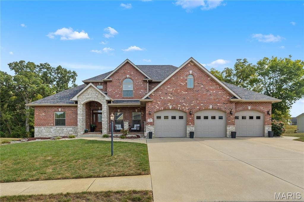 STUNNING SHOWSTOPPER IN WOODCREST ESTATES! Prepare to be impressed by the exceptional space, thoughtful design, and extensive upgrades found throughout this spectacular 5-bedroom, 5-bath home with a finished walkout lower level with privacy galore backing to a beautiful wooded area. From the moment you step inside, the grand two-story living room makes a statement with soaring ceilings, a dramatic wall of windows, custom built-in bookcases, and a beautiful stone fireplace that creates an inviting focal point. 
The newly remodeled gourmet kitchen in 2022 is truly the heart of the home, featuring an oversized quartz custom center island, top-of-the-line stainless-steel appliances, abundant cabinetry, and an impressive 8’ x 7’ walk-in pantry. The luxurious main floor primary suite offers a peaceful retreat with a spacious 15’ x 7’ walk-in closet, gorgeous tile walk-in shower, and relaxing corner soaking tub.
Upstairs, you’ll find an impressive layout designed for comfort and privacy, including a spacious ensuite bedroom with its own private bath, two additional generously sized bedrooms connected by a Jack-and-Jill bath, a versatile media/craft room, and the convenience of second-floor laundry.
The finished walkout lower level takes entertaining to another level with a 40 x 23 family/game room, stylish bar, second kitchen, and built-in beverage cooler. A fifth bedroom, full bath, and private office complete this incredible level, offering flexibility for guests, work-from-home needs, hobbies, or extended living.
The oversized garage measuring 36 x 23.8 provides plenty of room for vehicles, recreational toys, and storage. And that’s just the beginning! This remarkable home is packed with quality upgrades, custom touches, and thoughtful extras that truly set it apart.  Roof, gutters and downspouts just replaced in 2026, EV hook up, whole house water filter and softener, permanent exterior lighting, security camera system, pool ready 100 amp circuit and gas line for a future pool.
Make your appointment today with the listing agent or your favorite Realtor.