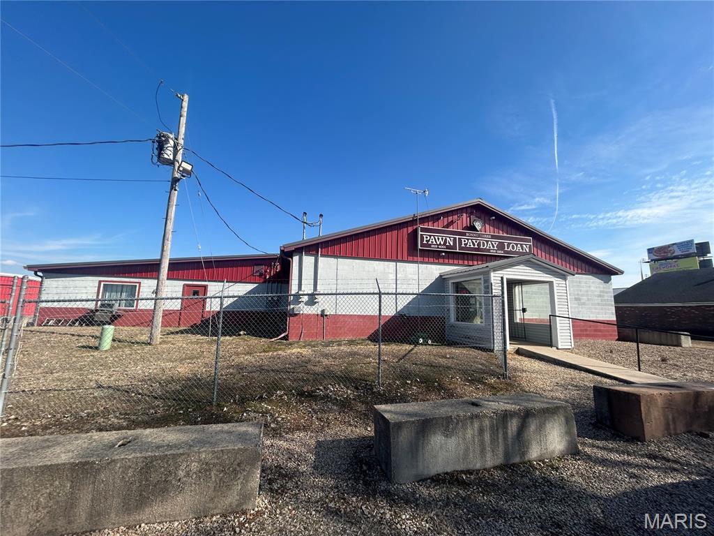 This established business, operating since 1998, offers a turnkey pawn shop operation with significant growth potential. Situated on 2.05 acres, it features over 400 feet of frontage on Hwy 67 and Berry Road, providing excellent visibility. The property includes two storage unit buildings with 35 units currently rented out, generating additional income, and a fenced area with room for expansion and additional storage units. Don't miss this opportunity to enhance your future with a proven business in a prime location.  Seller will sell the business separately from the commercial property.