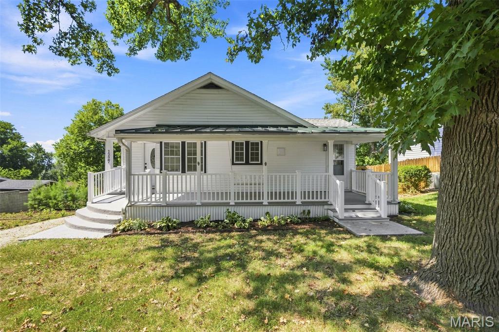 Come see this quaint home tucked away in the small-town charm of Crystal City, with easy highway access into St. Louis for work, entertainment, or everyday convenience.

You’ll feel right at home enjoying the rain from the adorable swing on the spacious covered front porch. The driveway offers ample parking for multiple vehicles, with plenty of room for a camper or boat.

Gardeners will love the multi-tiered vegetable garden along the side of the home, offering plenty of space to grow your own produce.

Inside, the sun-filled living room welcomes you with large windows that fill the space with natural light. Just off the living room is a spacious eat-in kitchen with access to the wraparound back deck—perfect for grilling, entertaining, or enjoying your morning coffee.

The main level features two bright and generously sized bedrooms, a full bathroom, and a convenient laundry room.

Downstairs, the fully finished basement adds even more living space, featuring a recreation area, updated second bathroom, an additional bedroom, and a bonus room that could easily serve as a fourth bedroom, home office, hobby room, or flex space.

With its charming outdoor spaces, flexible finished basement, ample parking, and convenient access to St. Louis, this Crystal City home offers the space and small-town feel you’ve been looking for.