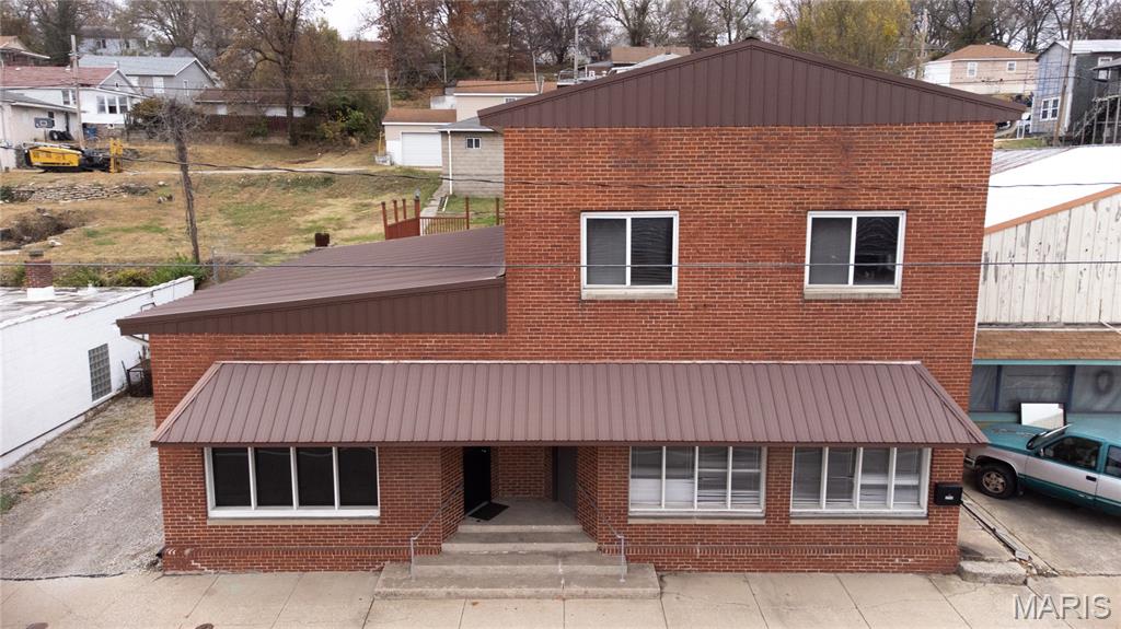 Prime Commercial Building with Income-Producing Apartment – Endless Possibilities!
This exceptional, all-brick commercial building offers outstanding visibility in a high-traffic retail corridor, perfect for serious investors or business owners seeking versatility and built-in value. Featuring a durable tin roof and two full stories, the upper level boasts a spacious 2-bedroom apartment already occupied with reliable tenants, meaning no need to find renters. Lease agreement can be negotiated with an accepted offer.
The lower level provides 2,251 sq ft of adaptable commercial space with two separate entrances, allowing you to operate one large business or easily divide it into two. Ideal for endless uses such as lash & brow studios, tattoo artists, solo estheticians, personal trainers, counselors/therapists, boutique retail, and more.
Recent updates include Google Nest fire/carbon detectors, all new exterior LED lighting, electrical improvements, and various modern upgrades throughout. Property also includes a 2-bay detached garage and two parcels, offering extra room and value.

This is a rare opportunity with excellent exposure, strong curb appeal, and built-in rental income. The potential here is tremendous—perfect for the right investor or entrepreneur ready to take advantage of a thriving location!