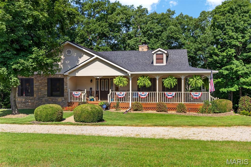 Nestled on 9 mostly wooded acres, this impeccably maintained property stick-built with 2x6 construction to allow for additional insulation offers the perfect blend of privacy, comfort, and functionality—with the rare advantage of 1 Gig fiber optic internet through Calabyte Technology, making remote work, streaming, and modern connectivity effortless in a peaceful country setting. Approximately 6 acres encompass the home, detached garage, and hobby shop, while an additional 3 wooded acres lie across Highway J, providing added privacy, recreational opportunities, or space to explore. 
The main level features luxury vinyl plank flooring, a spacious living room with a soaring vaulted ceiling and a stunning cultured stone wood-burning fireplace, a beautifully appointed kitchen with stone countertops, and a separate dining room perfect for everyday meals or holiday gatherings. Just off the kitchen, you'll find the convenient main-floor laundry combined with a half bath. The primary suite offers a walk-in closet and a private en suite full bath, while a second bedroom and an additional full bathroom complete the main level. Six-panel pine doors, cedar-lined window seats, and newer windows, add character and peace of mind.
The finished walkout lower level provides exceptional living space with an oversized third bedroom, a full bathroom, a large family room with a kitchenette, an open recreation area, and an additional non-conforming sleeping room or office. Live very comfortably by keeping warm and cozy during the colder months with the newer thermostat-controlled electric pellet stove to heat all of this space up!
Outdoor living is equally inviting with a wraparound front porch and a low-maintenance composite rear deck with vinyl railings overlooking the peaceful backyard. All of this under a new roof installed in 2024 on both the house and 26'x26' detached two-car garage!
Adding to this impressive estate is an 38' x 40' hobby shop completed in April 2024, offering endless possibilities for hobbies, storage, vehicles, or a home-based business. Professionally designed hardscaping and a garden behind the shop complete the outdoor setting. If you've been searching for a move-in-ready home with acreage, quality updates, exceptional outbuildings to include a spacious storage shed, modern high-speed internet, and the tranquility of country living, this property is one you won't want to miss. Call today to schedule for your tour before it is too late!