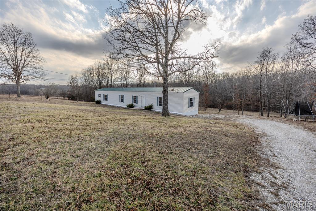 Enjoy the perfect blend of affordable living and wide-open space with this 3-bedroom, 2-bath mobile home situated on just under 6 acres. Tucked away for privacy, this property offers plenty of room to spread out, start a garden, or create your own small hobby farm. Whether you're looking for peaceful country living or space to grow and explore, this property provides endless possibilities at an accessible price point. Bring your animals, your outdoor plans, and make this acreage your own!