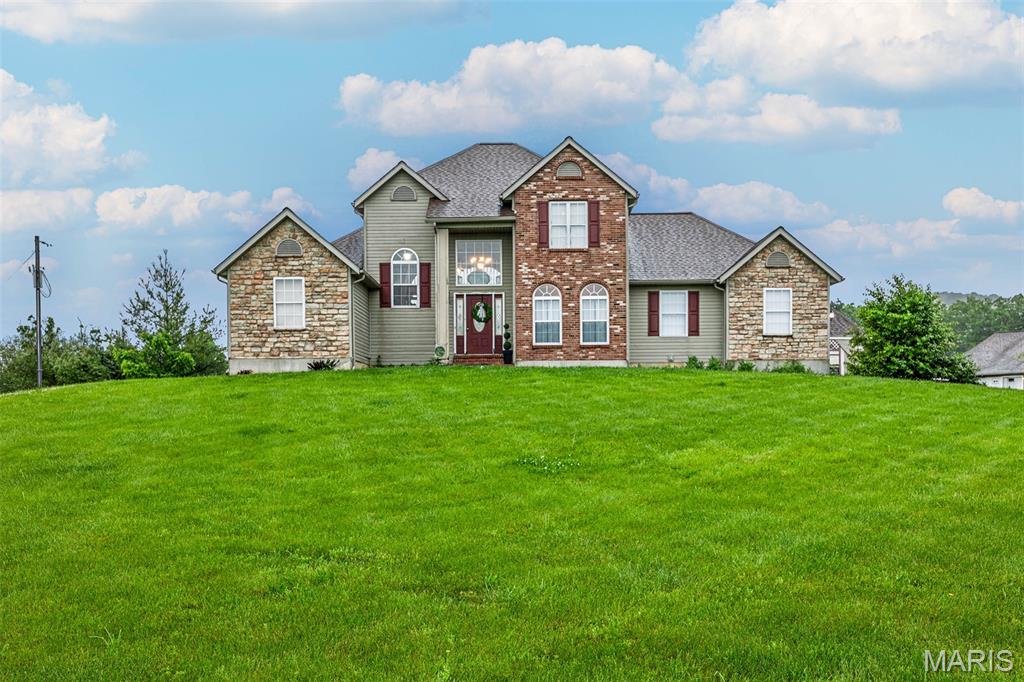 More photos coming soon! Showings start Wed May 20th! Located just 4 miles outside Hermann, this beautiful 3-acre property offers space, flexibility, and country living with no restrictions. The main home features 3 bedrooms and 3.5 baths, including a main-level primary suite with private bath and main-floor laundry for added convenience. Upstairs offers 2 additional bedrooms and a full bath, while the lower-level basement includes another full bath and an additional garage ideal for storage, hobbies, or workshop space. A standout feature is the separate second residence, perfect as a mother-in-law suite, guest house, or income-producing rental, complete with 2 bedrooms, kitchen, living room, and its own garage. Outside, enjoy 3 scenic acres with plenty of room for gardening, recreation, or simply taking in the peaceful setting. The inground pool is getting a fresh update with new concrete work underway and a brand-new liner to be installed. Relax on the front porch and take in the amazing sunset views, this is country living at its best, just minutes from town.