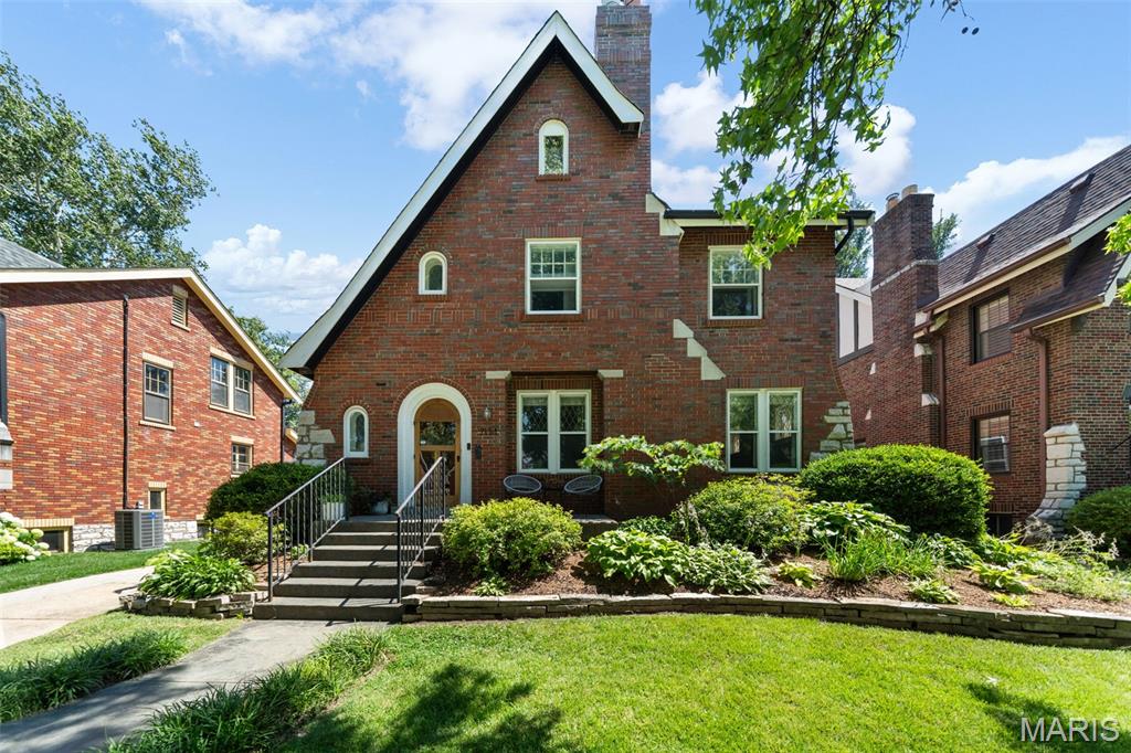 OPEN SUN 6/28 from 12-2PM! Est. 1930, this beautifully updated 5-bedroom, 2.5-bath University City home offers over 2,700 square feet of finished space in the highly walkable University Park neighborhood. Combining timeless character with thoughtful updates, this stately 2-story brick home features striking curb appeal, mature landscaping, and a welcoming front porch. Inside, you’ll find spacious, light-filled rooms with hardwood floors, arched doorways, terrazzo detailing, leaded glass windows, and a gas fireplace. The open main level includes a generous living room, formal dining room, a convenient half bathroom and an updated kitchen featuring a 2022 48" Bertazzoni 6-burner dual fuel range, a great center island, abundant cabinetry, and premium appliances—perfect for everyday living and entertaining. The second floor offers separately zoned HVAC for comfort, three generous bedrooms and two updated bathrooms, including a true primary suite with a large walk-in closet and private bath. The 3rd floor offers two additional bedrooms—or great dual home office options—and lots of additional storage/closets. The walk-out lower level adds even more living space with a fantastic bonus theater room, laundry area, and plentiful storage. Outside, enjoy multiple entertaining spaces including a patio and new 17x16 composite deck overlooking a privacy-fenced backyard. An expanded driveway and detached two-car brick garage with built in shelving, workbench and opener provide ample off-street parking and storage. Just steps from Winslow’s Table, Heman Park, Lewis Park, Jackson Park, and the Delmar Loop, 7134 Stanford offers the perfect blend of historic charm, modern updates, and a vibrant walkable lifestyle.