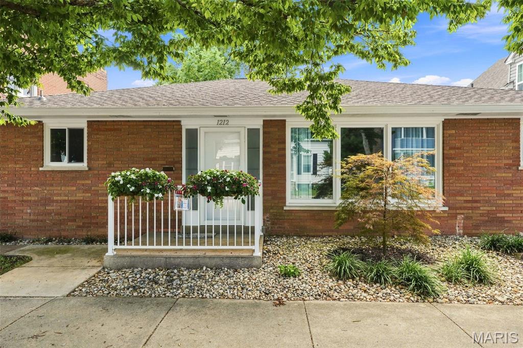 Rare Opportunity! This charming all-brick property offers exceptional flexibility.  Beautifully updated, this 2-bedroom property features an open-concept floor plan with a renovated kitchen offering abundant cabinetry, updated appliances, a center island, and seamless flow into the living area. The bright four-season room provides additional flexible space.   Recent updates:  new roof & gutters (2026), new electric service A/C & furnace and sewer line (from alley to concrete = 2024).  The private primary bedroom is located at the rear of the home with an additional second generously sized bedroom and bonus flex room providing plenty of space.  The spacious laundry room includes a utility sink and stand-up shower.  A rear-entry driveway provides valuable off-street parking and leads to a one-car garage with additional storage. The large white vinyl-fenced backyard offers plenty of room for entertaining, recreation and gardening.  Located within walking distance of the town square, restaurants, shopping, St Paul Church and School, and entertainment, this unique property is ideally suited for a variety of permitted uses. Whether you're seeking an amazing home or an entrepreneur seeking a storefront with living quarters, a professional in need of office space, an investor, or a homeowner wanting room for a home-based business, this property offers the rare opportunity to own a building that can serve as a residence, a commercial business, or a combination of both.