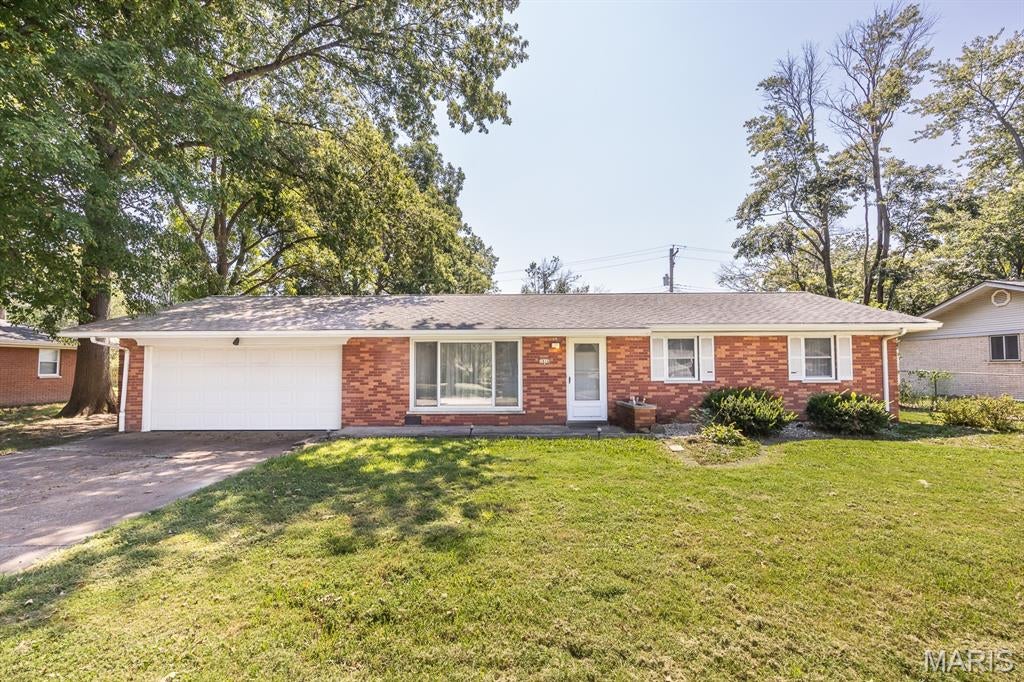 All-brick ranch offering a spacious, light-filled layout. The large living room flows into the dining room and an open kitchen with amble cabinets and counter space, and room for everyday cooking or entertaining. The primary bedroom includes a private half bath, plus two additional bedrooms and a full hall bath. The dining room opens to a patio and a level backyard—ideal for outdoor gatherings. Home includes a 2-car attached garage and has been well maintained over the years but would benefit from updating to make it your own. Property is being sold as-is. Buyers to verify all information.