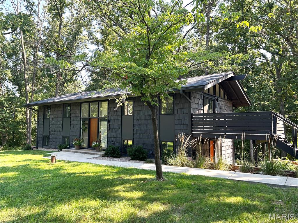 A rare opportunity to own a Bloodgood-designed mid-century modern home, reimagined for modern life on 1.68 private acres in O'Fallon. Built in 1964 and featured in Better Homes & Gardens, this 2,064 sq. ft. split-level pairs distinctive architectural character with an extensive top-to-bottom renovation. Inside, you'll find 3 bedrooms plus a flexible fourth room ideal for a home office or guest space, and 2 fully renovated bathrooms. The updated kitchen features quartz countertops and KitchenAid appliances, while the primary suite offers a vaulted bathroom and walk-in closet. Since 2021, the home has undergone an extensive renovation including new windows, HVAC with three mini-split systems, a new roof, upgraded 200-amp electrical service, new septic system, upgraded well pump, water heater, water softener, exterior paint, sidewalks, and landscaping. Outside, enjoy mornings on the restored deck or newer patio overlooking 1.68 private acres, a detached oversized two-car garage with EV-charger-ready outlet, and a powered storage shed. Distinctive architecture, substantial acreage, and major system upgrades make this a home that's difficult to replicate and ready for its next owner!