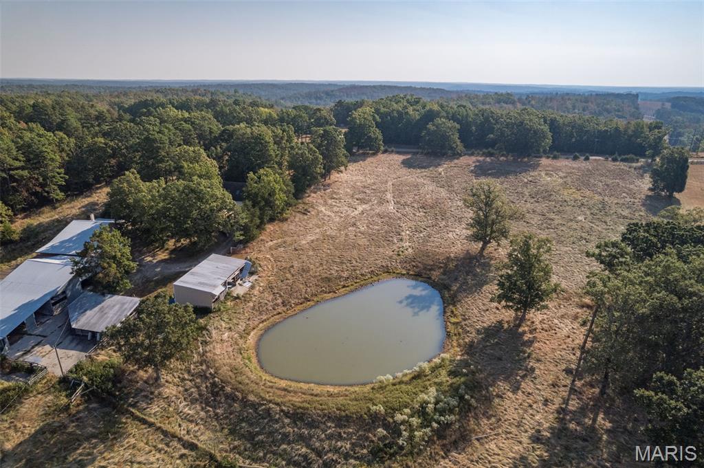Calling all cattle farmers!  All that is needed for this 96 +/- acre farm on the outskirts of Fredericktown is the livestock. This farm is fenced and cross fenced giving you a few different options for running your cattle. Property has road frontage on both County Road 238 and 229 providing convenience of two different entry points. Key Features: • Maintenance shed - 1250 sq ft. • Feeder barn – 600 sq ft. • Equipment shed – 1000 sq ft. •Main barn – 5040 sq ft.  This will hold 150 round bales of hay.  There are also two custom-designed hay islands. This area contains a Maintenance shop, Carpenter shop, and Craft Room.  These areas have electric, concrete floors, and are temperature controlled. • 4 car carport – 1175 sq ft. • Home – approx. 3300 sq ft and being sold as-is.  This farm creates effortless management of livestock in some of the most picturesque countryside in southern Missouri.— where forest meets farmland and privacy meets possibility. Call today to schedule your personal tour.