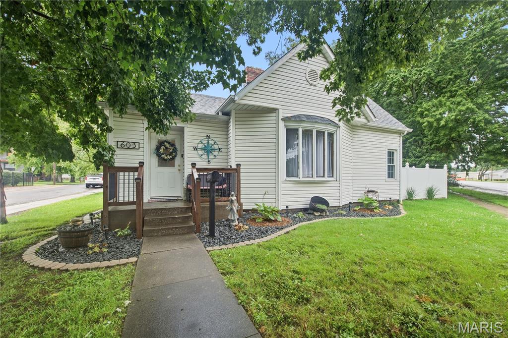 This adorable home boasts two bedrooms, one full bathroom on the main level. Large dining room and living room. It showcases charming features such as arched doorways, hardwood floors and a cozy fireplace in the living room. The upper level has two bonus rooms, closet space and attic access to potentially expand the finished space even more. Located on a corner fenced lot near several city parks and restaurants. You can enjoy your evenings unwinding on the back patio. Detached garage and covered carport offer plenty of parking space also